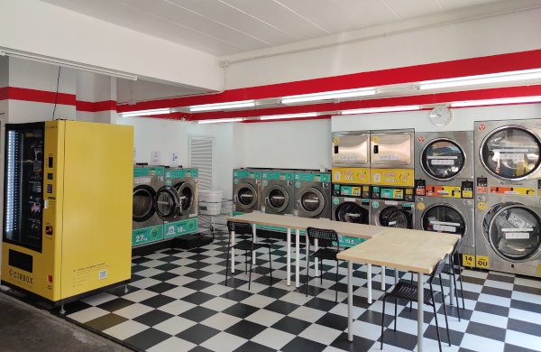 Quik Laundry store front with 24 hour self-service washing machines